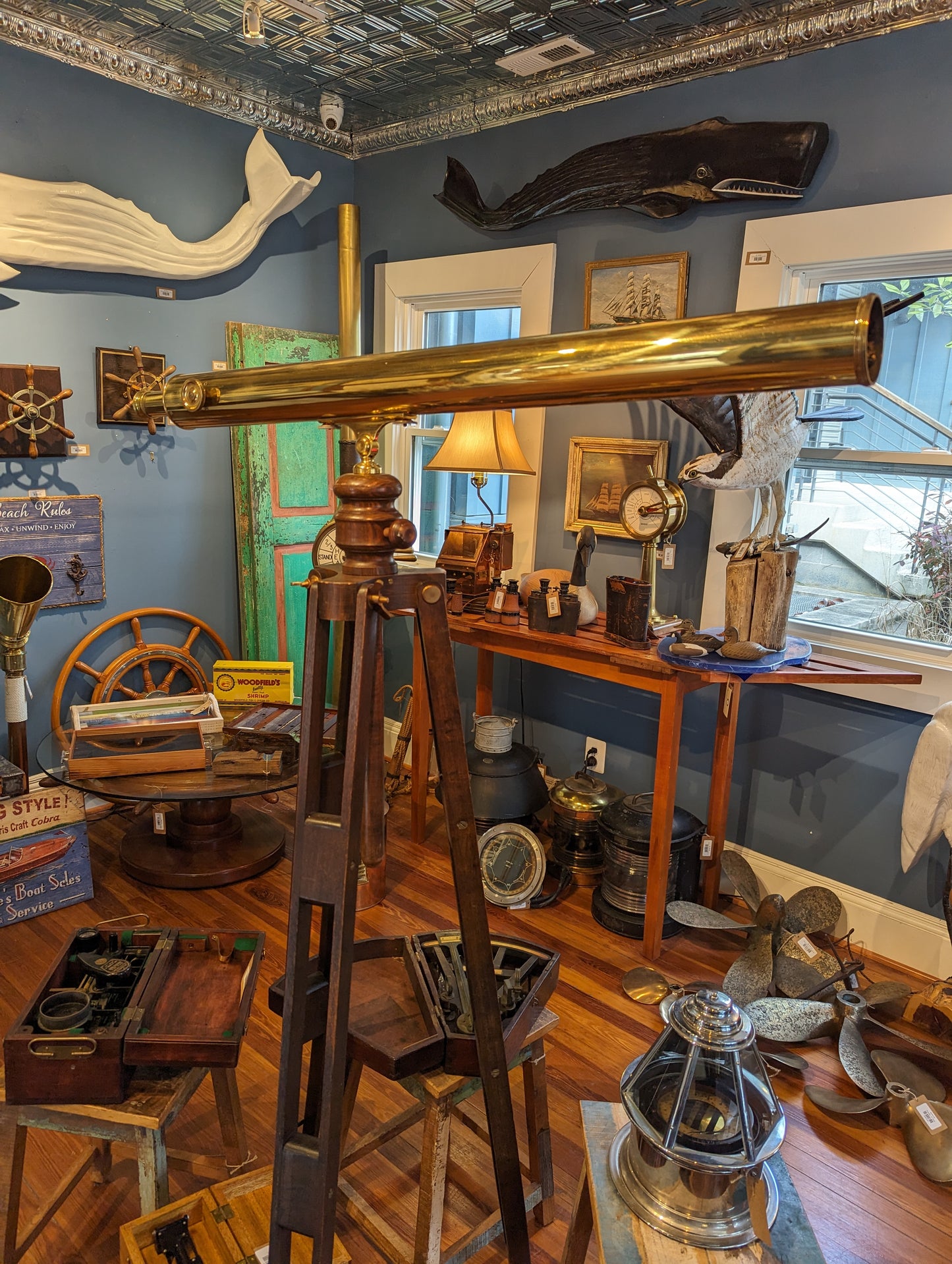 Large brass telescope on wooden tripod