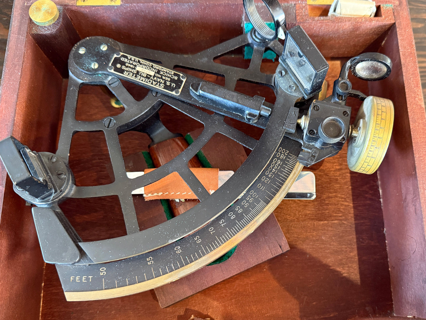 Vintage sextant in a wooden case on a wooden surface