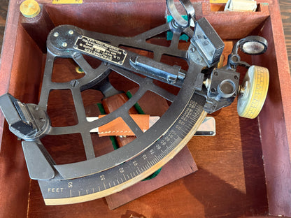 Vintage sextant in a wooden case on a wooden surface