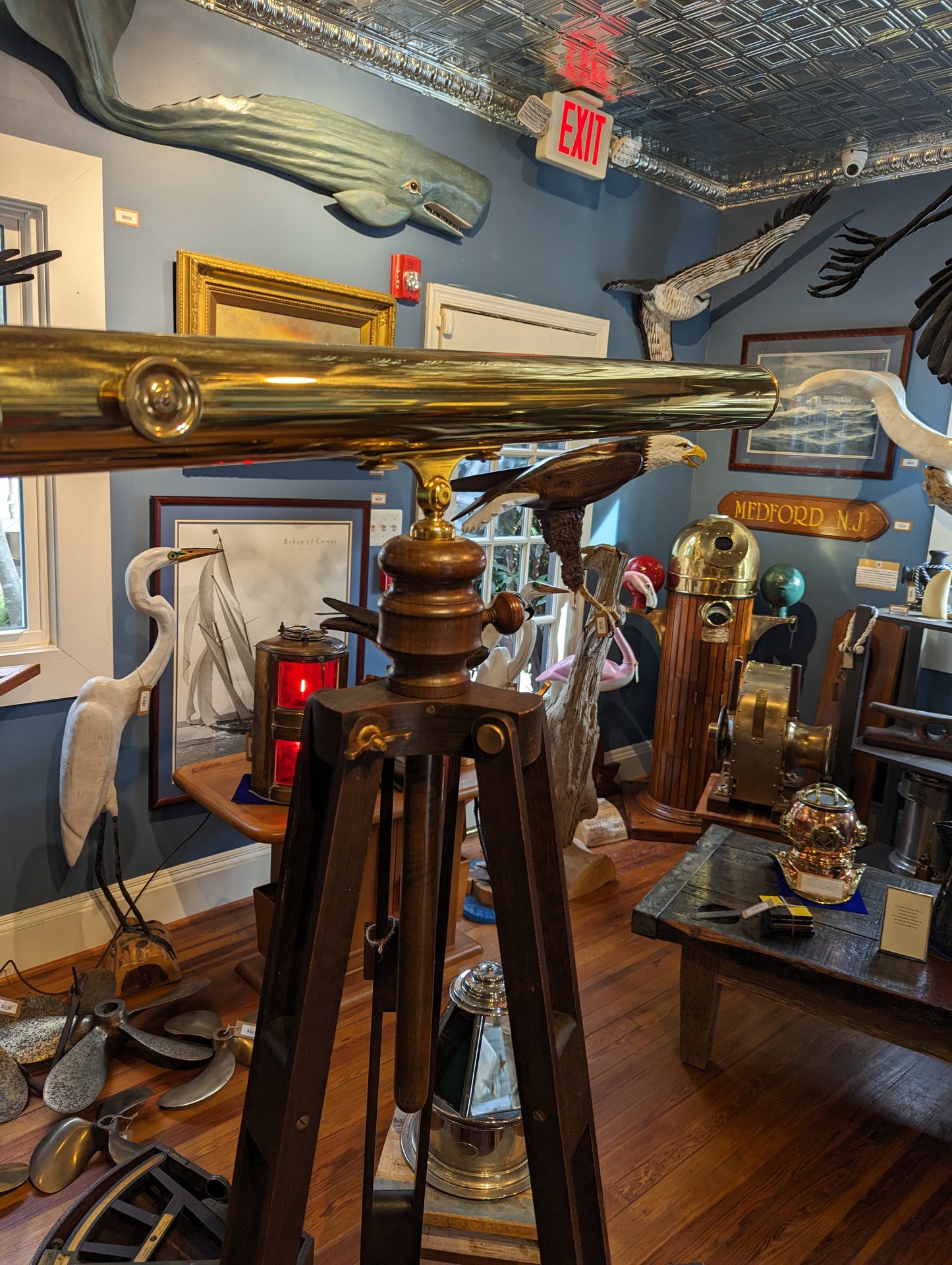 Large brass telescope on wooden tripod