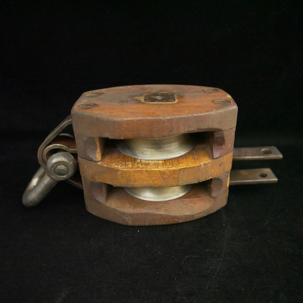 Antique 13-inch double sheave wooden block pulley.