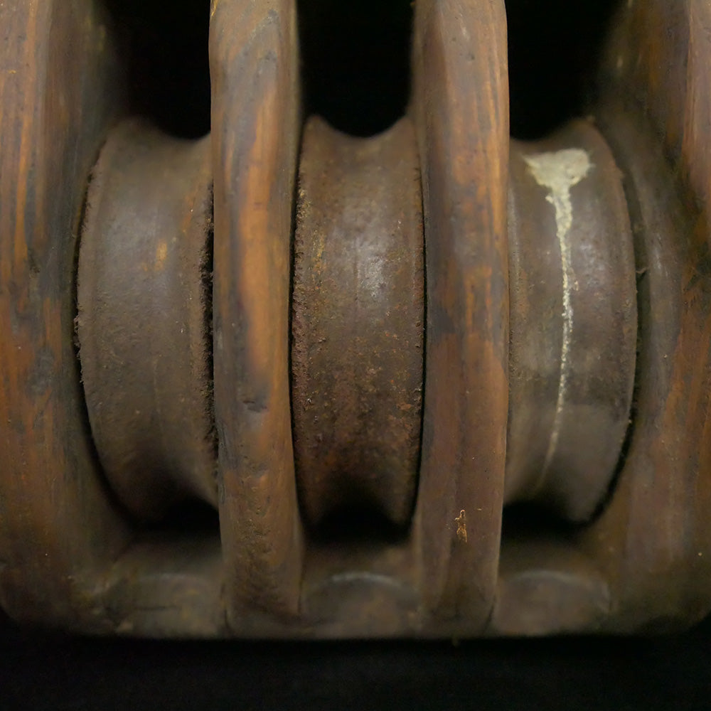 Antique 14.5-inch triple sheave wooden block pulley.